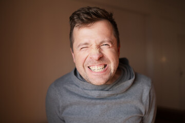 Middle Aged European Man with a Wide Fake Smile, Emotional Portrait