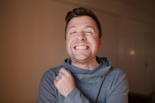 Middle Aged European Man with a Wide Fake Smile, Emotional Portrait