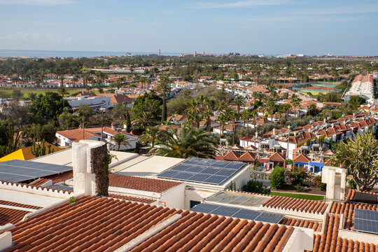 Photograph from Playa del Ingl&eacute;s to Maspalomas of a densely packed resort and residential area. Spanish island of Gran Canaria, in the Canary archipelago. Warm climate, palm trees, solar panels. 