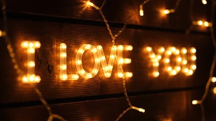 A romantic video message with warm glowing lights spelling out love words