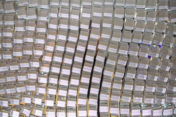 Close-up of geometric crystal elements forming a reflective grid pattern.