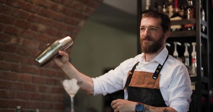Bartender Shaking a Cocktail in a Metal Shaker at a Bar