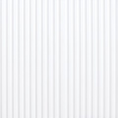 A white corrugated metal roof sits atop a sturdy building, complemented by sleek metal siding that enhances its modern industrial aesthetic.