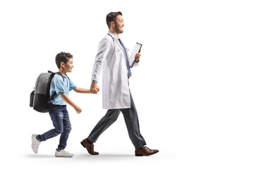 Doctor walking with a schoolboy carrying a backpack