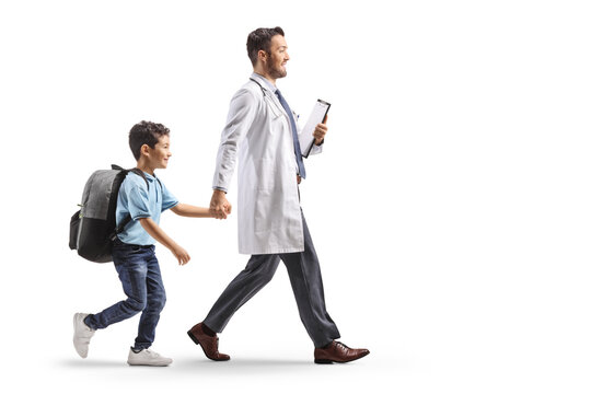 Doctor walking with a schoolboy carrying a backpack