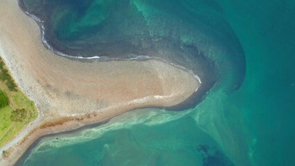 Fototapeta premium Aerial view of sandy shoreline and turquoise sea 