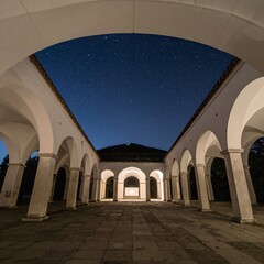 A stunning long row of elegant stone arches, each intricately designed, casting soft shadows on the ground, creating a sense of depth and perspective.