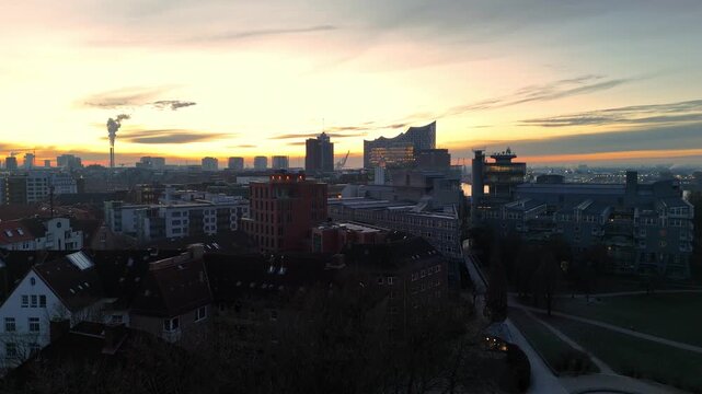 Aerial drone footage (ascent) over the skyline of Hamburg at sunrise