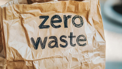 Zero waste paper bag with eco-friendly message on blurred background, eco concept, recycling compaigns, ecological activiities advert, nature protection blogs, eco friendly web,  clean planet