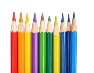 Fototapeta premium A row of sharpened, colorful pencils arranged in a rainbow order on a black background