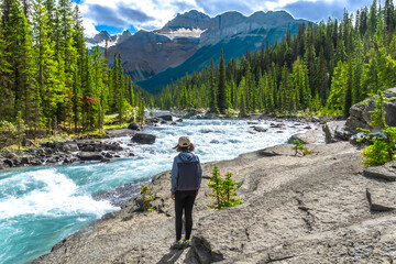 Hiker admiring mistaya canyon and river in banff national park