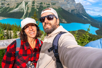 Tourists taking selfie at peyto lake in banff national park