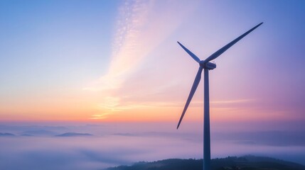 Fototapeta premium Silhouette of a windmill turbine against a foggy twilight sky with rainbow colors and gentle clouds