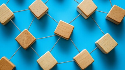 Connecting wooden blocks on a blue background demonstrates teamwork and collaboration among individuals in simple tasks fostering unity