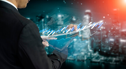 A business professional analyzing complex financial data on a transparent screen with a vibrant cityscape illuminated at night, showcasing modern technology in finance. Impute