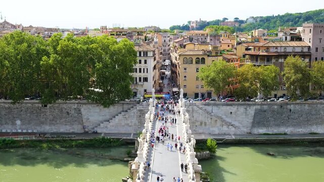 elevated rome ponte sant angelo pedestrians between white marble statues above green tiber river historic streets lead castel sant'angelo to view italy roman empire emperor 
