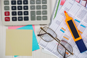Business and accounting supplies arranged in a composition on an office desk. Top view.