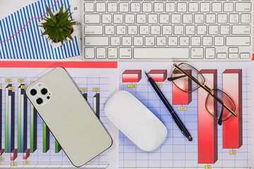 Business and accounting supplies arranged in a composition on an office desk. Top view.