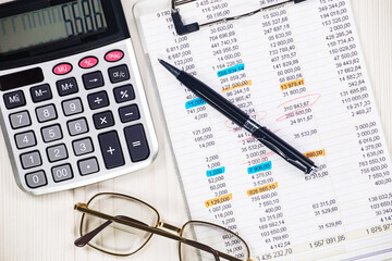 Business and accounting supplies arranged in a composition on an office desk. Top view.