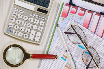 Business and accounting supplies arranged in a composition on an office desk. Top view.