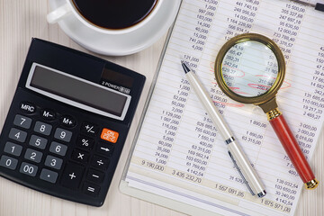 Business and accounting supplies arranged in a composition on an office desk. Top view.