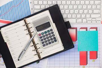 Business and accounting supplies arranged in a composition on an office desk. Top view.