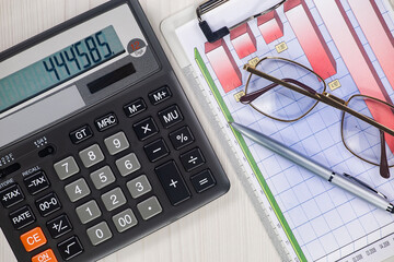 Business and accounting supplies arranged in a composition on an office desk. Top view.