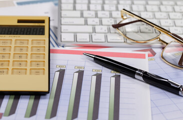 Business and accounting supplies arranged in a composition on an office desk. Top view.