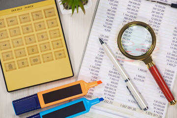 Business and accounting supplies arranged in a composition on an office desk. Top view.