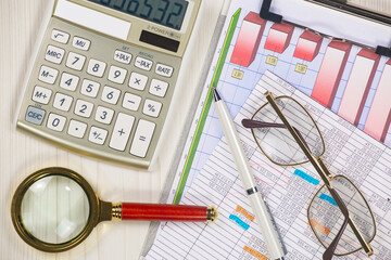 Business and accounting supplies arranged in a composition on an office desk. Top view.