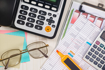 Business and accounting supplies arranged in a composition on an office desk. Top view.