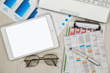 Business and accounting supplies arranged in a composition on an office desk. Top view.
