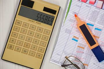 Business and accounting supplies arranged in a composition on an office desk. Top view.