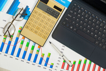 Business and accounting supplies arranged in a composition on an office desk. Top view.