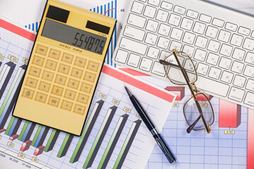 Business and accounting supplies arranged in a composition on an office desk. Top view.