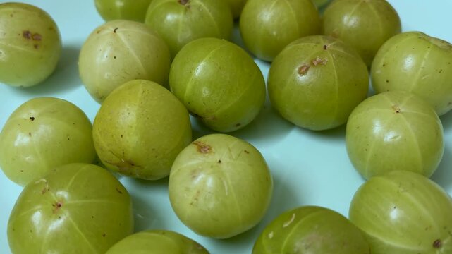 indian gooseberry amla arranged on blue plate flat lay