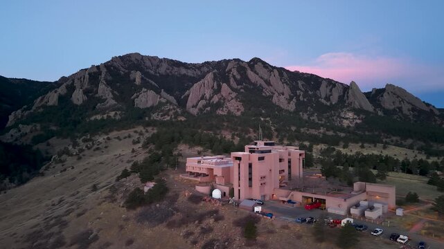 National Center of Atmospheric Research (NCAR) panning shot with mountains.