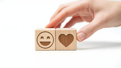 Hand placing wooden blocks with emoji and heart symbol