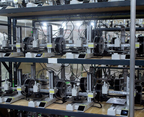 Many 3D printers printing object. 3D printers printing model from molten plastic. 3D printers creating shape from molten plastic flowing out of extruder. New modern 3D Printing additive technologies