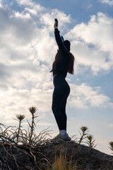 Woman reaching up connecting with nature outdoors