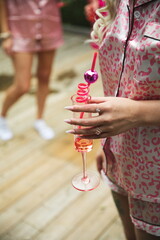A woman holding an alcoholic beverage at a party in Ontario, Canada.