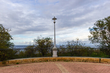 Scenic Sea View From a Brick Terrace With Classic Lamp Post and Ocean Horizon