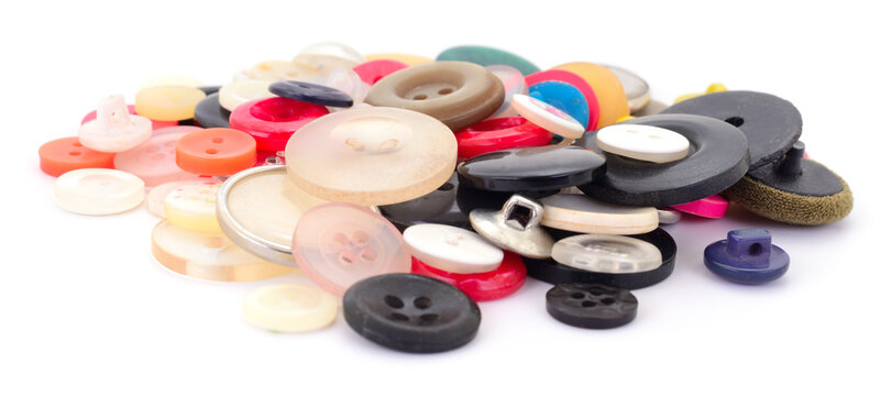 Heap of various sewing buttons isolated on white