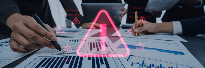 Business professionals engage in a collaborative analysis of various reports, highlighting critical warnings and alerts in a modern office setting to ensure informed decision-making. Trope