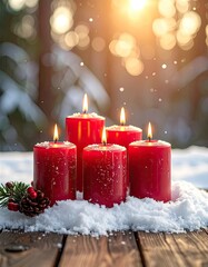 Four burning red Advent candles nestled in fresh snow on a rustic wooden surface outdoors.