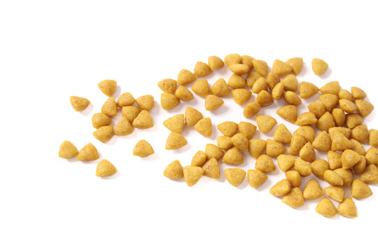 Isolated kibbles spread on white background. Hydrolyzed soy protein pet food. Veterinarian prescribed hypoallergenic diet for cats or dogs. Low molecular weight peptides. Selective focus.