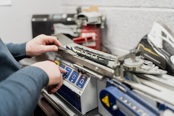 Professional hockey skate sharpening machine used by elite teams for precise blade maintenance, highlighting automated sports equipment servicing and ice hockey support industry