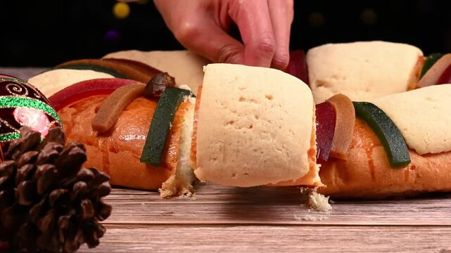 Someone serving a slice of rosca de reyes (Three Kings' Cake), Epiphany Day in Mexico, Family gathering