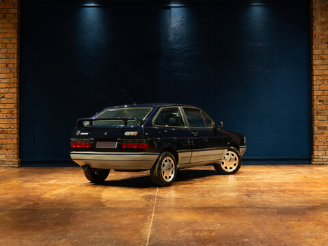 Blue Volkswagen Gol GTI rear three quarter view, Retro sports car on concrete