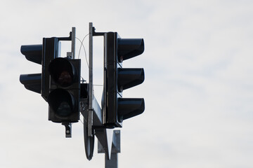 Modern traffic light system mounted on street pole against sky, highlighting urban traffic management equipment, road signaling technology, and transport infrastructure